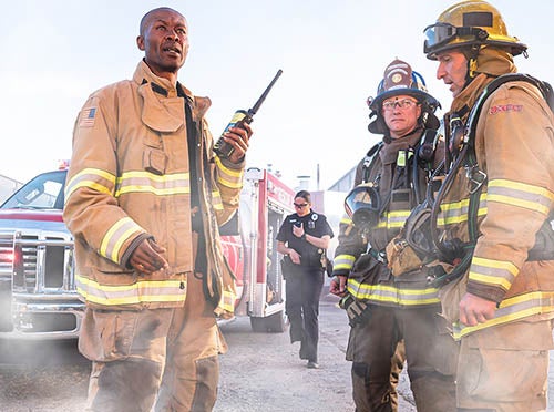 Firefighters with NFPA-compliant XL Extreme Fire Radio