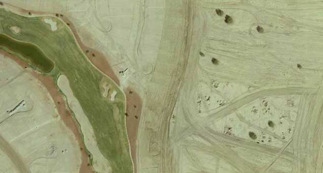 Above is an aerial photo of a golf course housing development with construction underway in Loveland, Colorado.