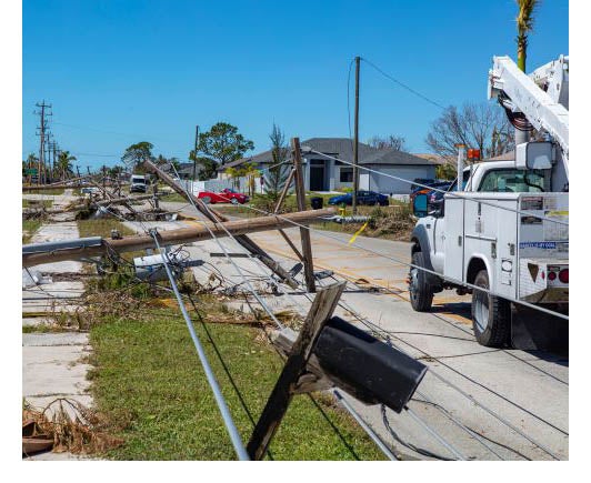 Utility truck at site of hurricane damage