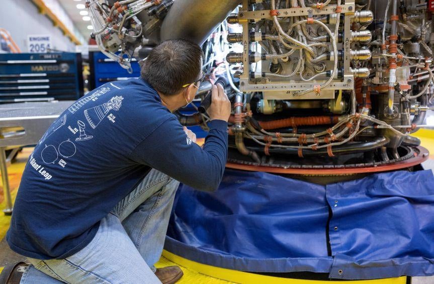 An Aerojet Rocketdyne employee inspects a component