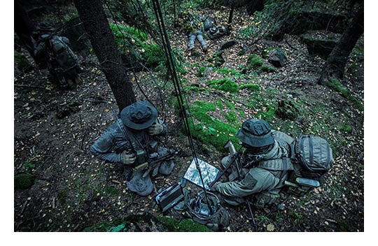 camouflaged soldiers in forest