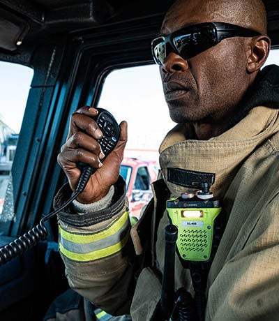 Firefighter using XL-185 mobile P25 radio