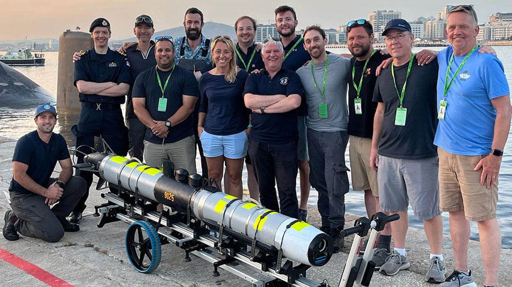 Crew members take a photo with an IVER