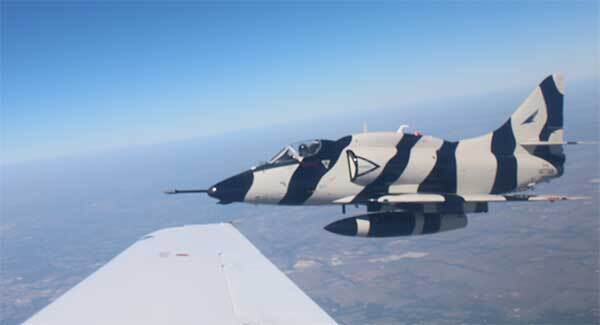 jet in flight as seen through another airplane's window