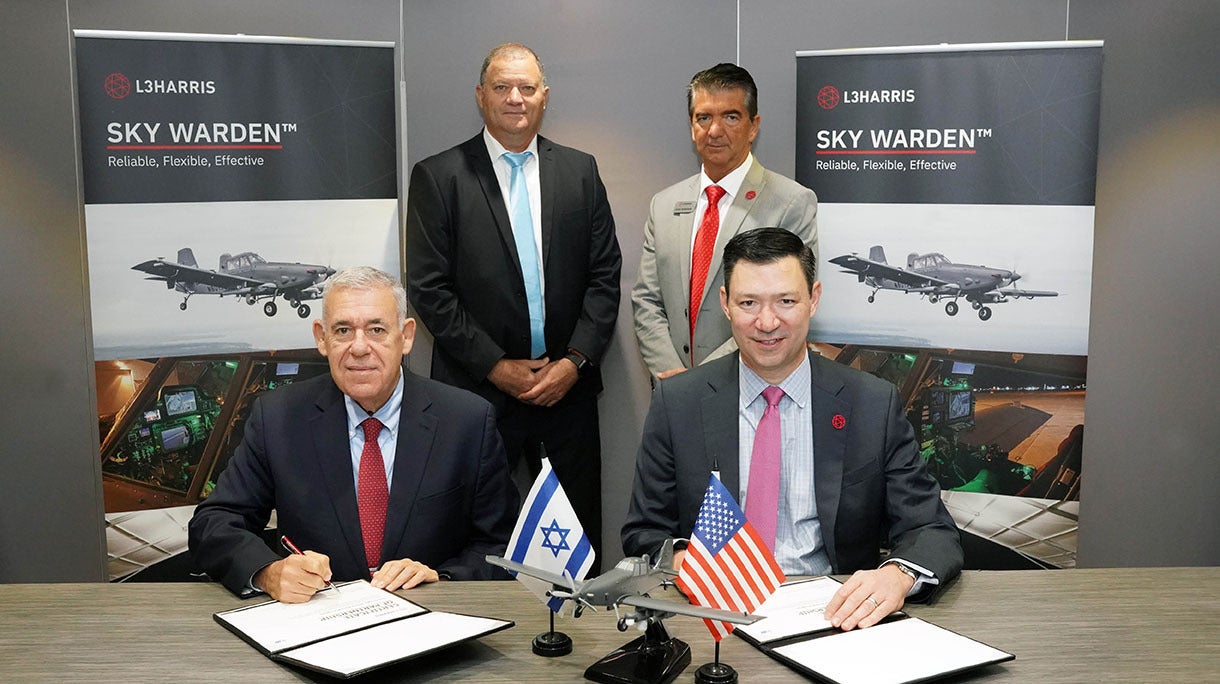 Representatives from IAI and L3Harris sign documents