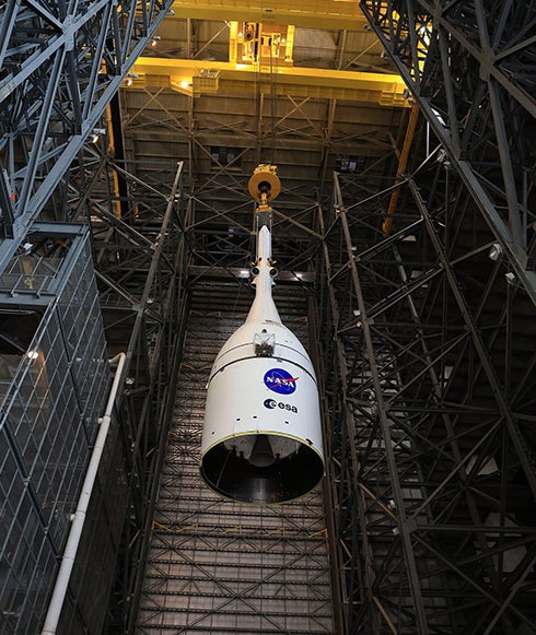 The Orion spacecraft for NASA’s Artemis II mission, fully assembled with its launch abort system, is lifted ontop of the Space Launch System (SLS) rocket in High Bay 3 of the Vehicle Assembly Building at Kennedy Space Center in Florida. 