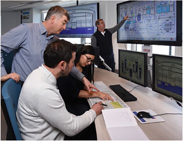 engineers in front of PCs