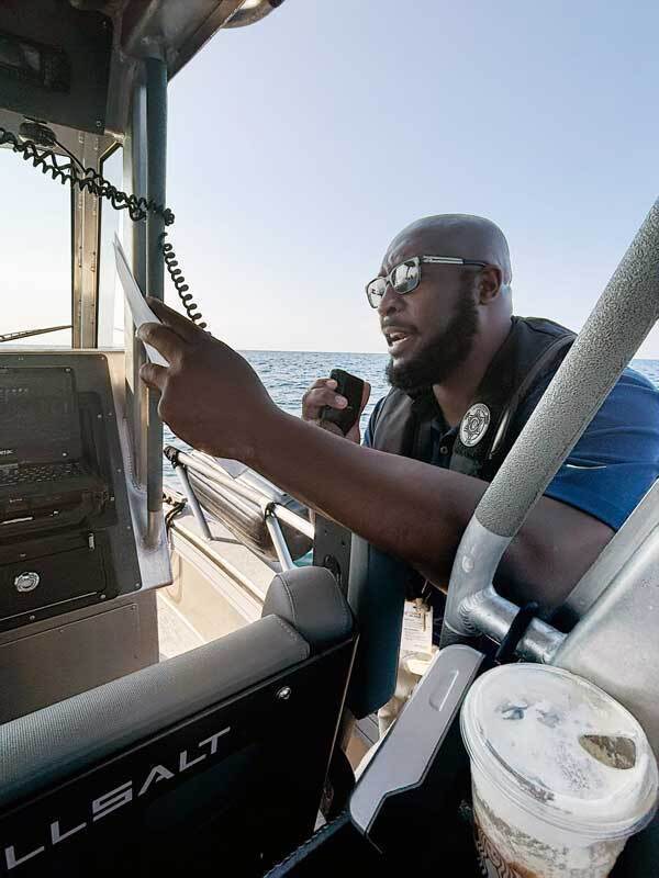 Man on radio on boat at sea