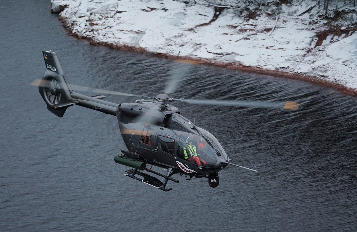 Airbus H145M helicopter test firing laser-guided missile over water
