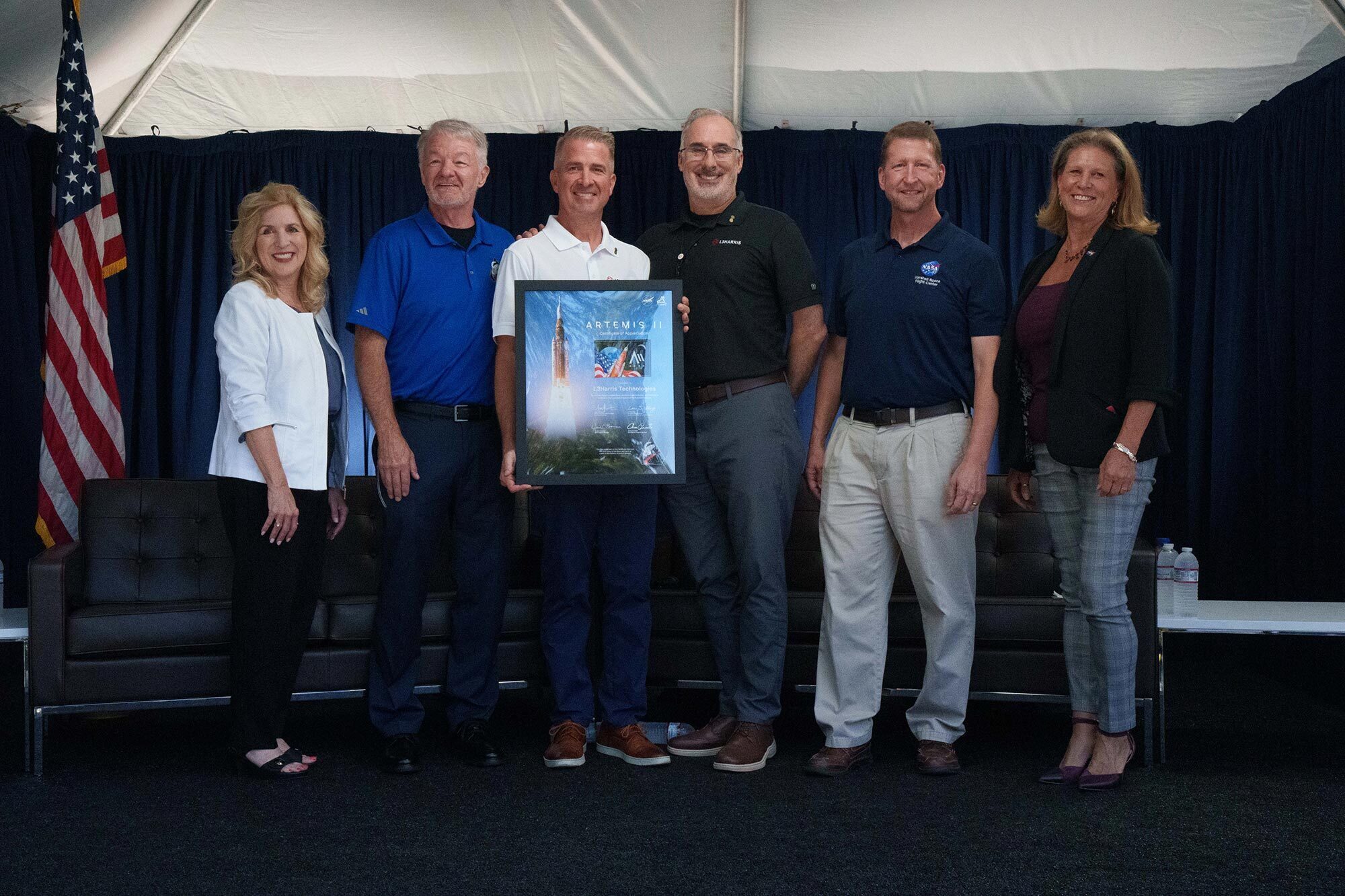 NASA leaders presented L3Harris with an item flown in space as a token of appreciation for the company’s contributions to the successful Artemis II mission. Pictured from L to R: Dr. Sharon Cobb, Acting Deputy Program Manager, SLS, NASA; Johnny Heflin, Manager, Liquid Engines Element, NASA; Ken Bedingfield, President, Missile Solutions, L3Harris; Mike Lauer, General Manager and Program Manager, RS-25 SLS, L3Harris; and Dr. Lori Glaze, Associate Administrator, Human Spaceflight Mission Directorate, NASA. 