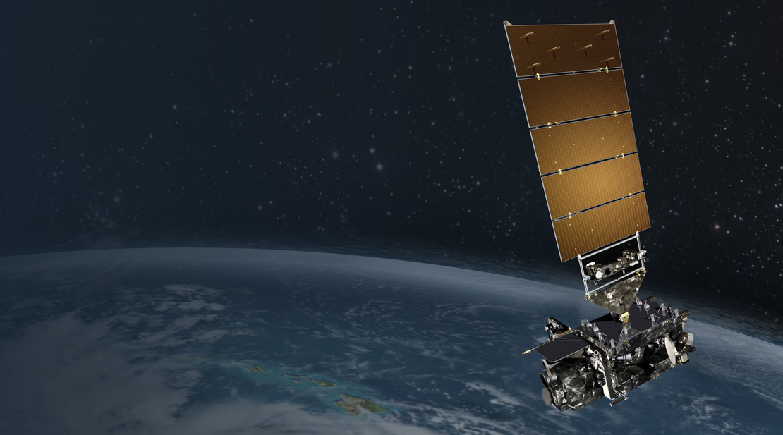 Satellite hovers in space over earth