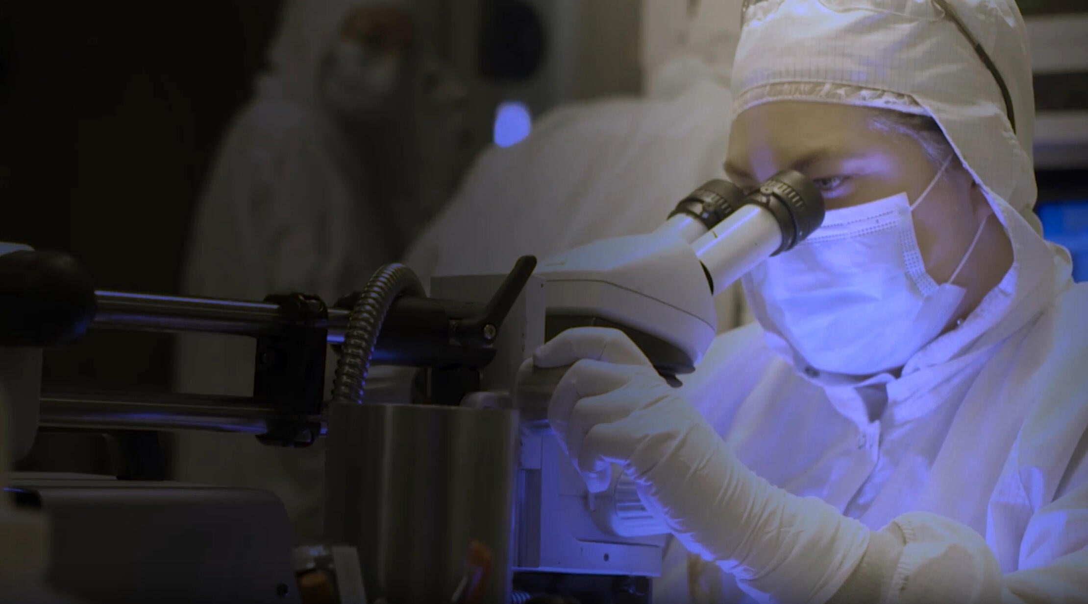 Employee works at microscope