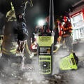 NFPA-compliant XL Extreme Fire Radio with firehose, firefighters and fire truck in background