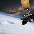 Satellite hovers in space over earth and the eye of a hurricane