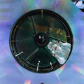 Optical Technician lays on diving board suspended between NASA's Nancy Grace Roman Telescope's mirrors.