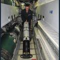 Sailor aboard USS DELAWARE turns an Iver4-900 AUV around for storage outside the torpedo room