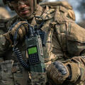 Joint Forces warfighter with AN/PRC-163 handheld radio