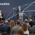 L3Harris Christopher E. Kubasik speaks at a podium at a facility