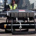 An L3Harris GNAT Heavy Duty (HD) electro-mechanical release unit is carrying the StingRay Torpedo on the Malloy T600, thumbnail image.