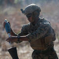 U.S. Marine loads a round