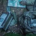 Pieces of military communications devices lie on the ground