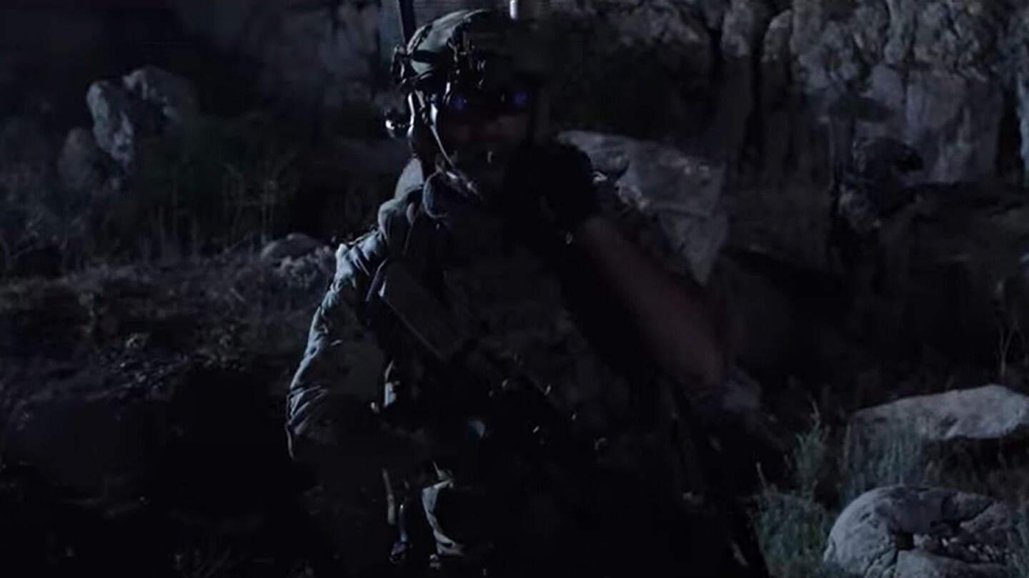 Warfighter walks through battlefield