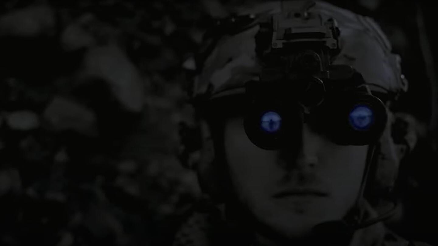 Soldier wears night-vision goggles