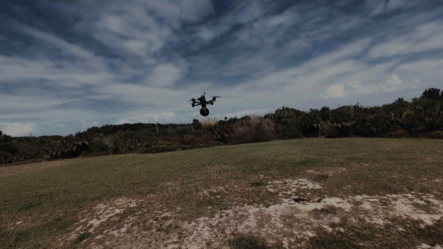 Still frame from Fiber-Optic Tether products video, flying drone with tether pack