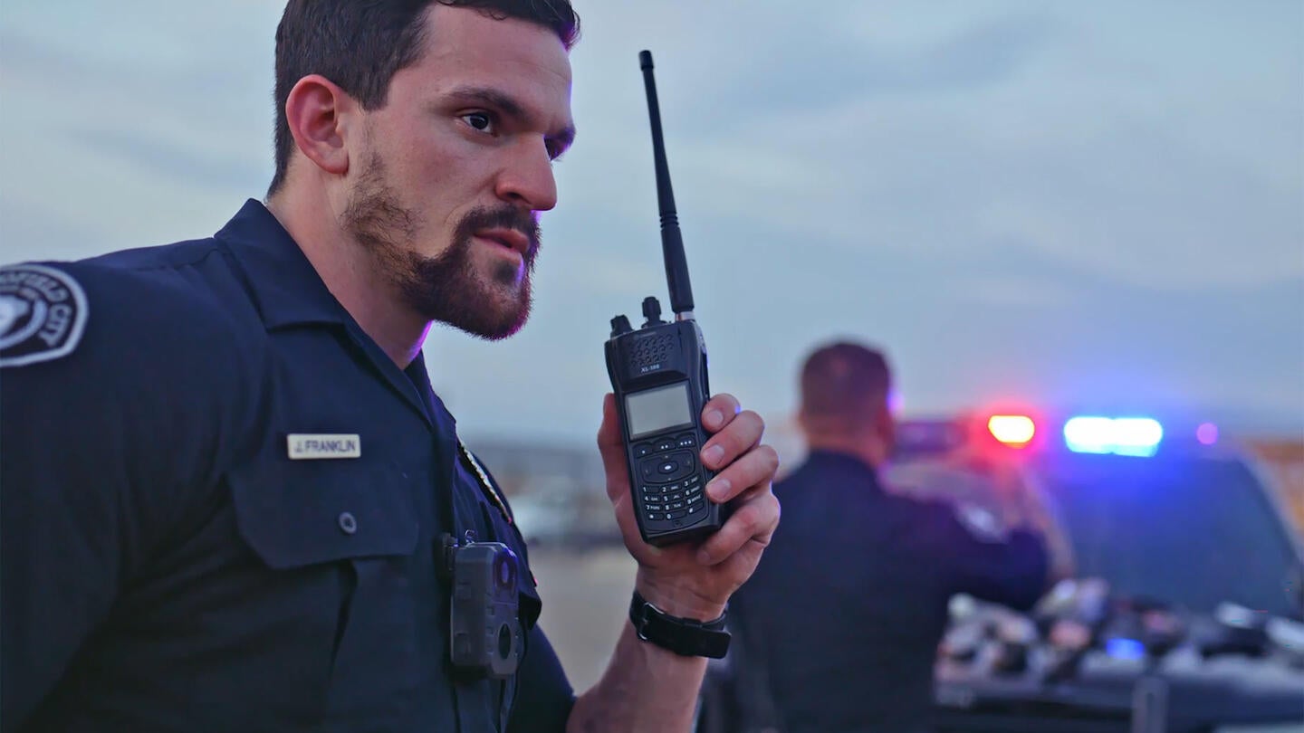 Two47™ Device Management video thumbnail - police with portable radio