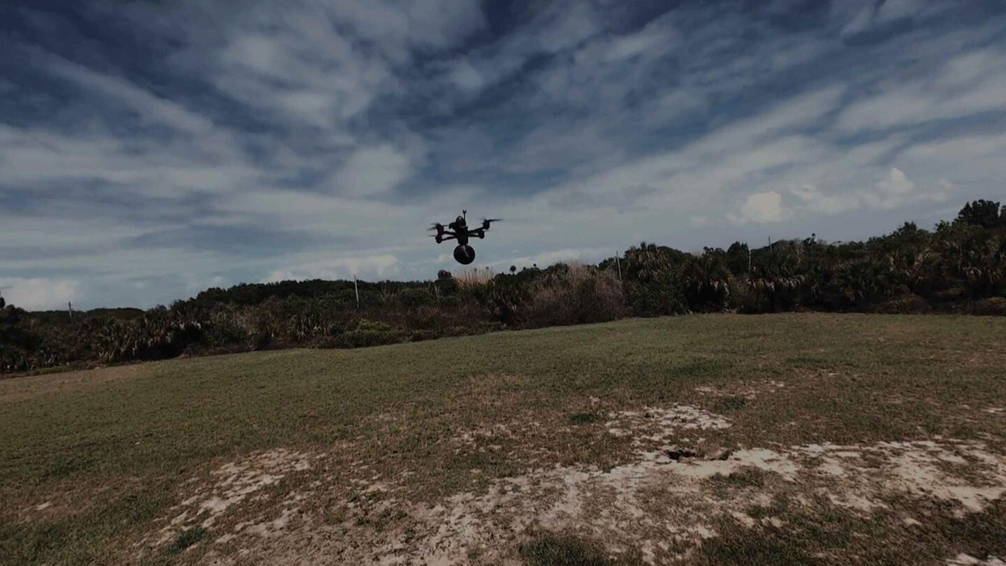 Still frame from Fiber-Optic Tether products video, flying drone with tether pack