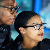 Navy soldiers looking at a computer screen