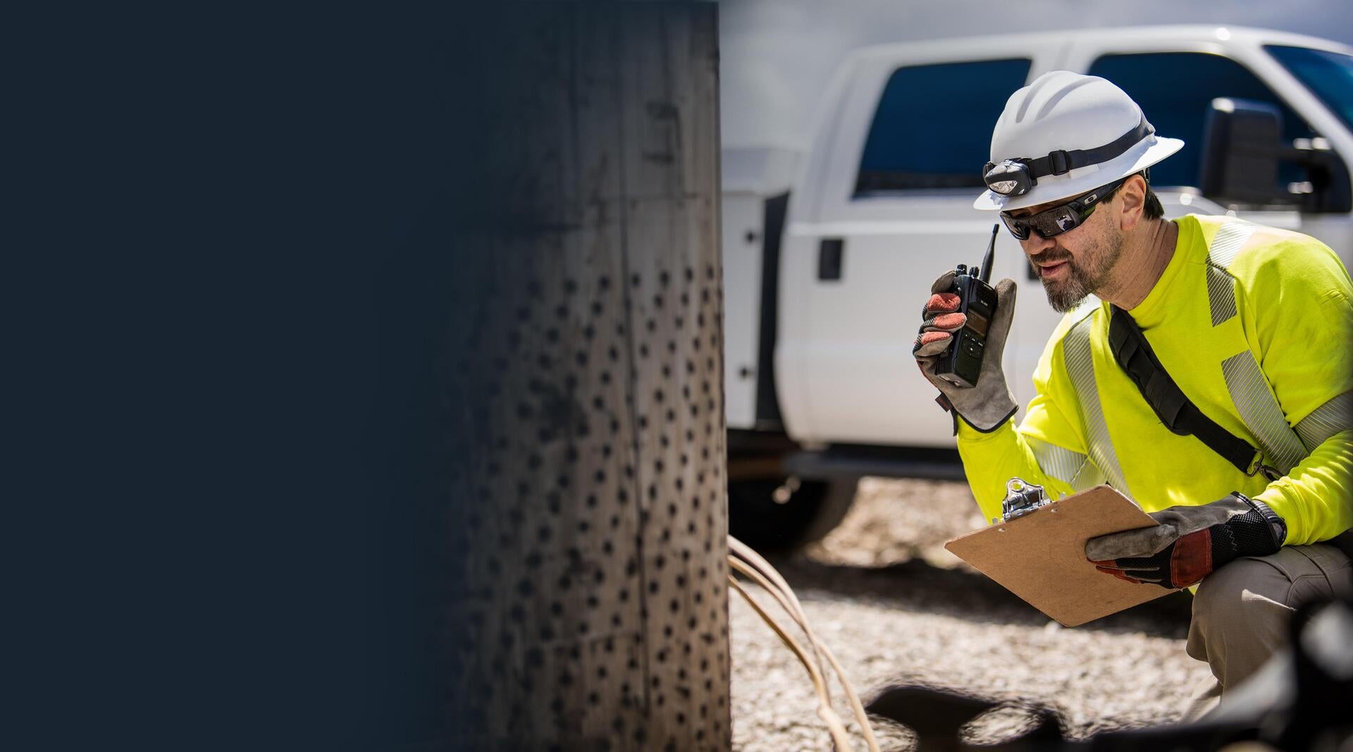 Utility worker with portable radio