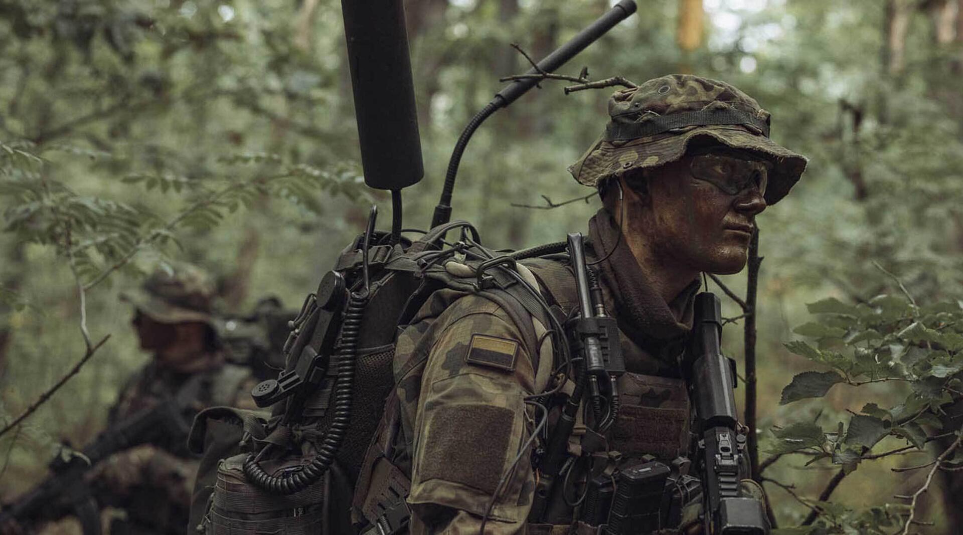 soldier in the forest using L3Harris Tactical Communication Radios