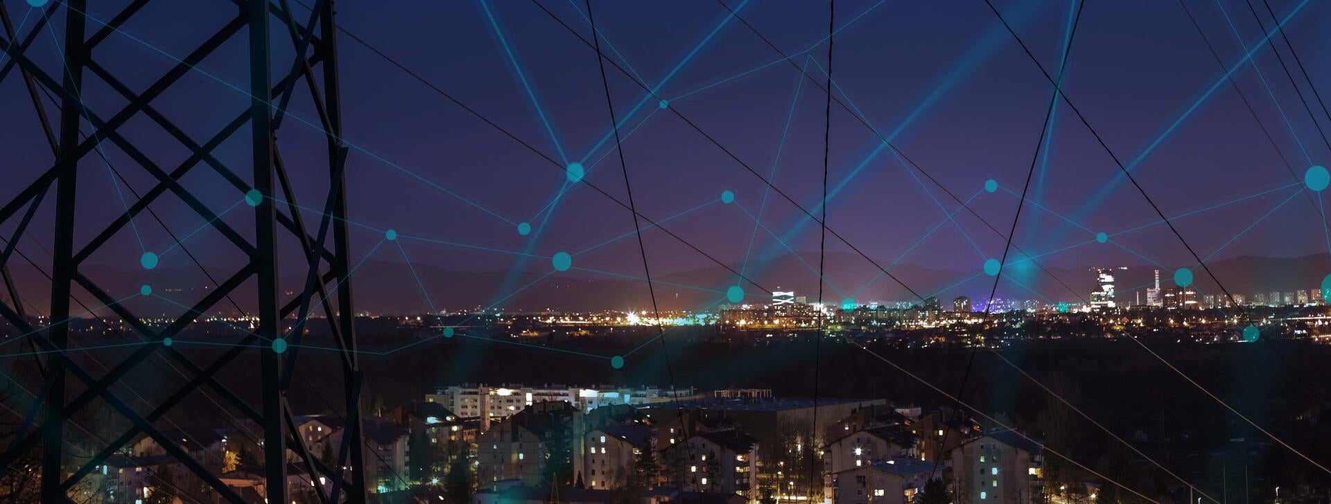 Utility tower with city at night