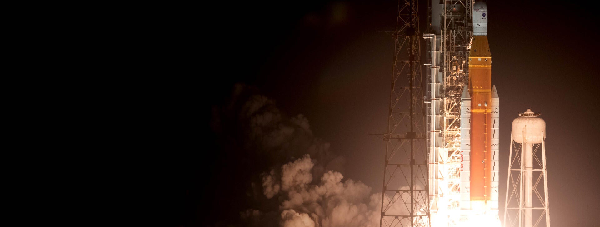 Space launch rocket launches and lights up night sky