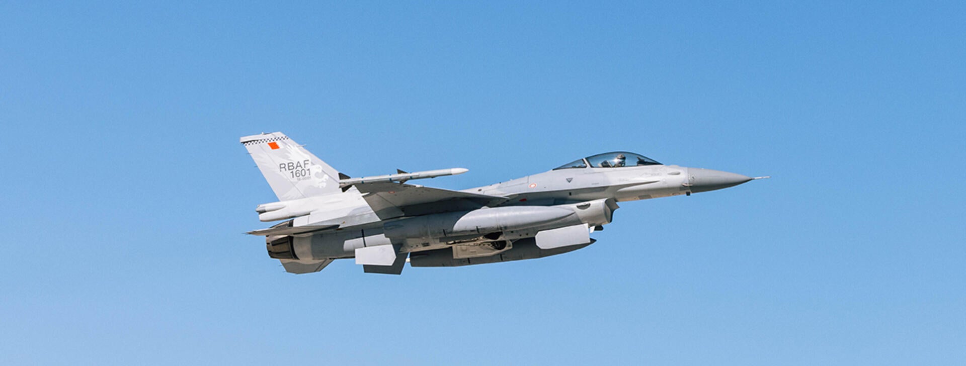 Jet soars through blue sky