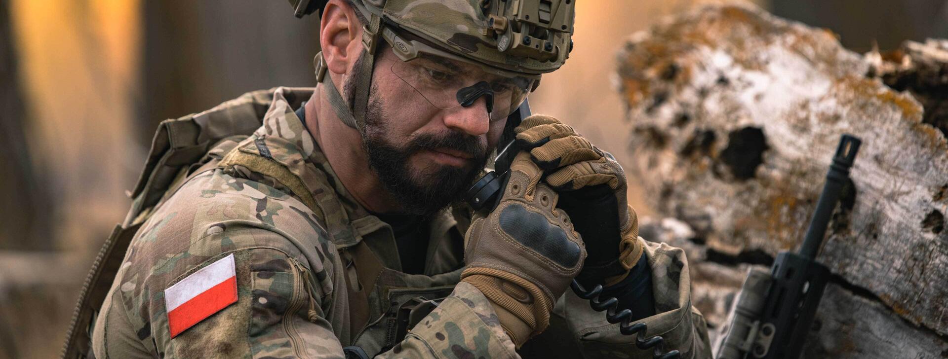 Polish soldier on tactical communications radio