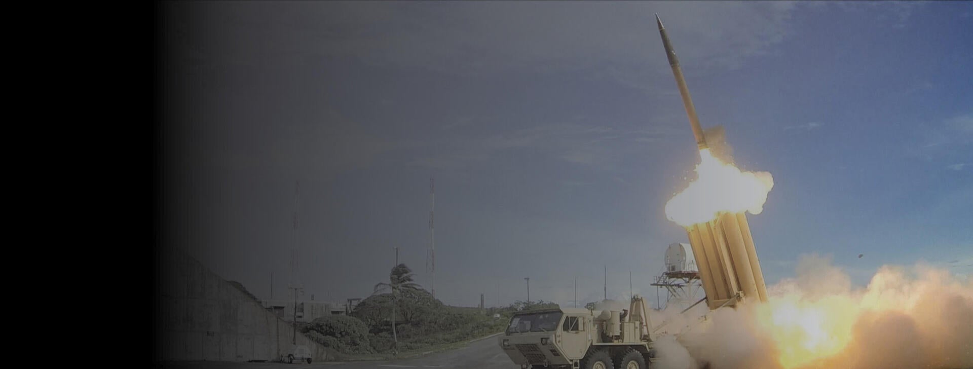 THAAD missile launches in background