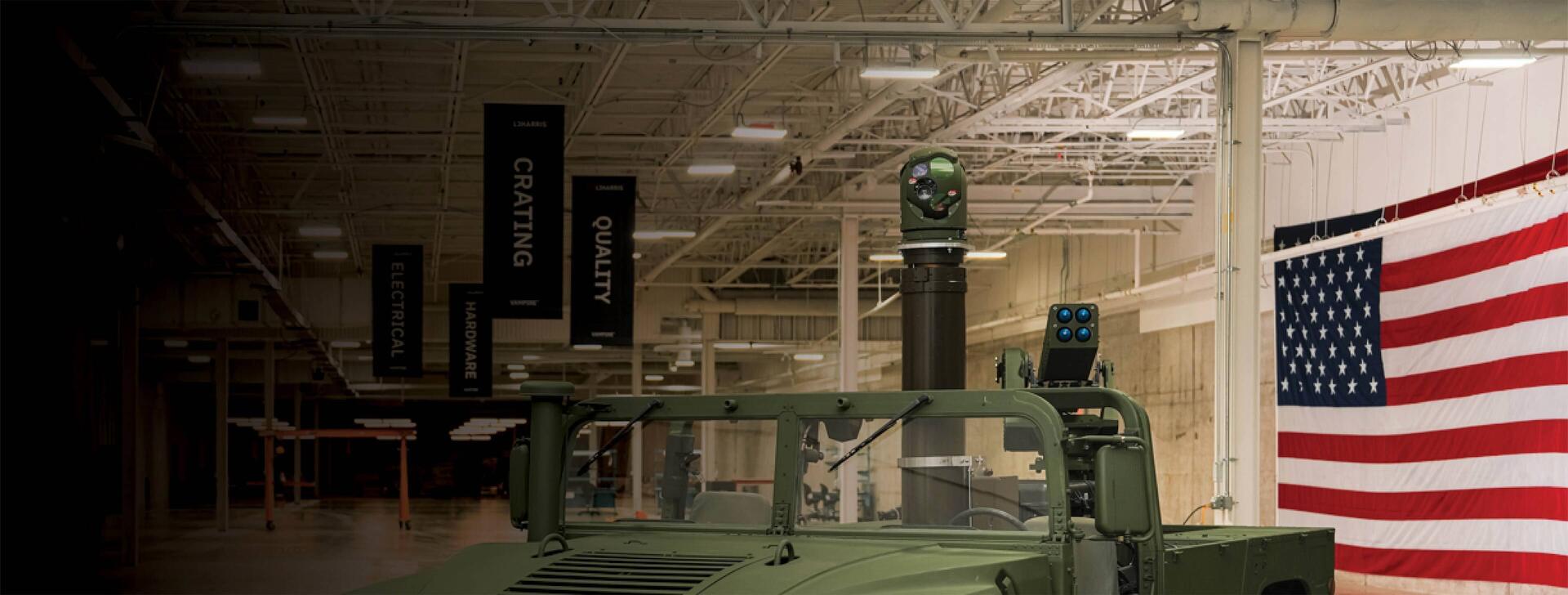 VAMPIRE system outfitted on vehicle inside facility with american flag in the background