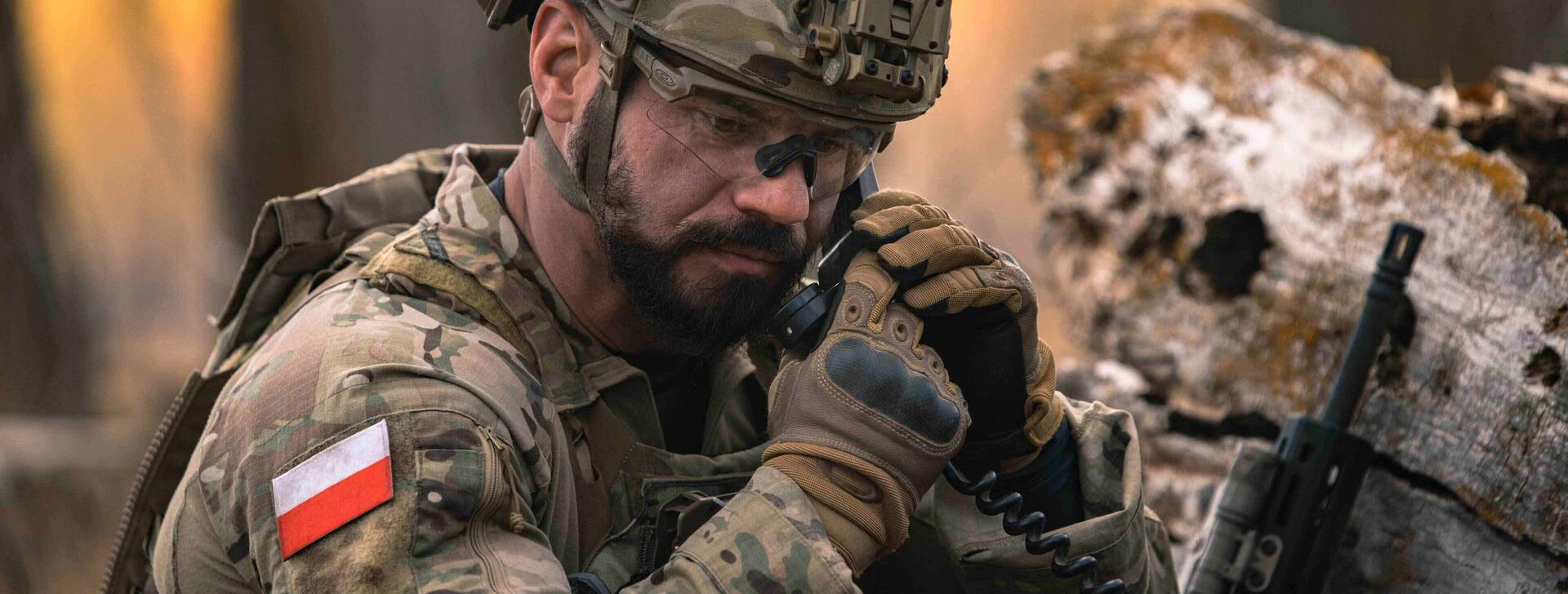Polish soldier on tactical communications radio