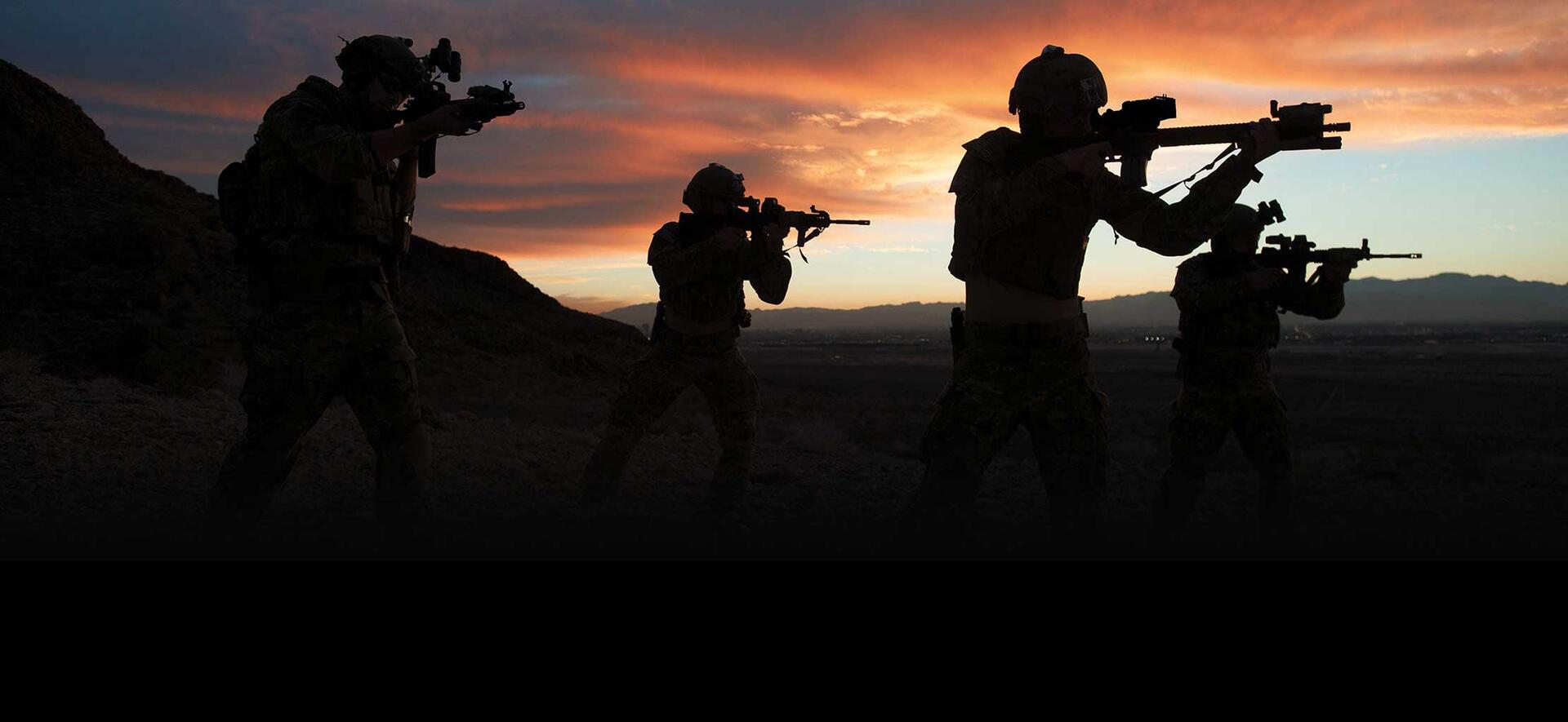 Soldiers on the field in silhouette