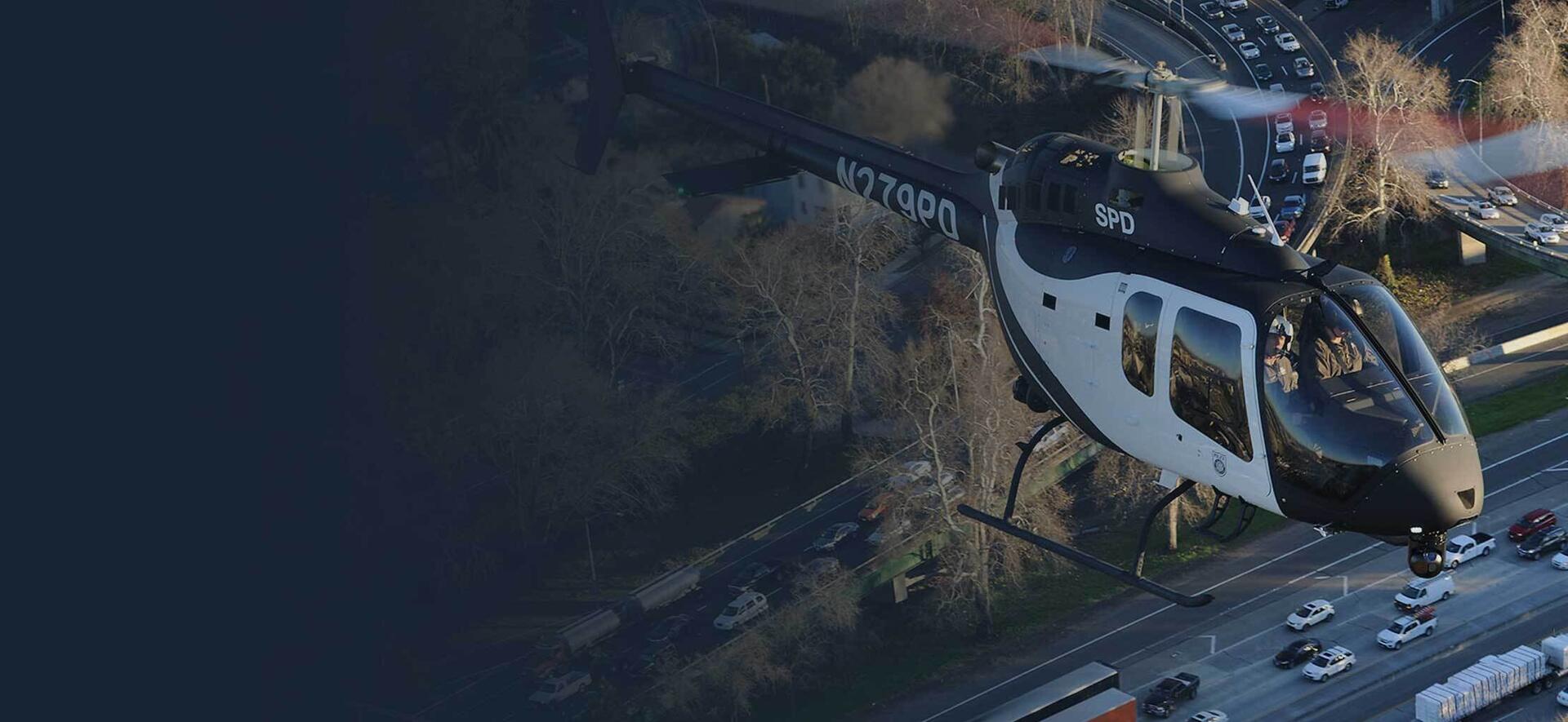 Police helicopter with the WESCAM MX-10 installed over traffic