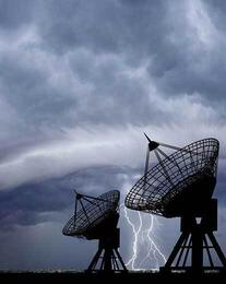 antennas with lightening in the background