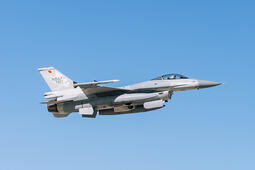 Jet soars through blue sky