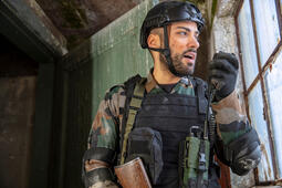 Soldier speaks into radio