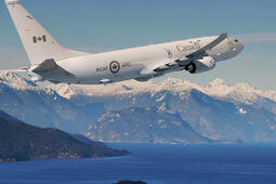 P-8A flies over mountain range