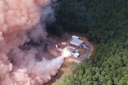 A solid rocket motor test fires at a facility
