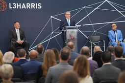 L3Harris Christopher E. Kubasik speaks at a podium at a facility