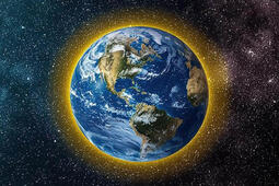 Earth from space with a yellow glow around the atmosphere