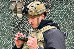 Soldier inspects his devices